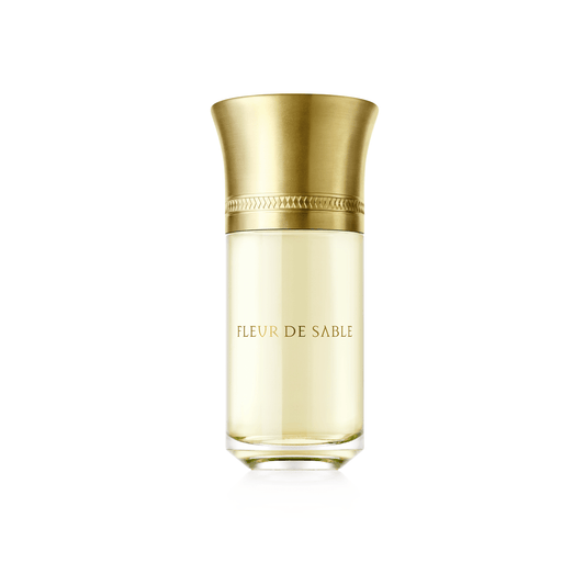 Flacone di profumo LIQUIDES IMAGINAIRES FLEUR DE SABLE da 100 ml – fragranza unisex ispirata ai deserti, con note saline, speziate e floreali, racchiusa in un elegante packaging dorato.